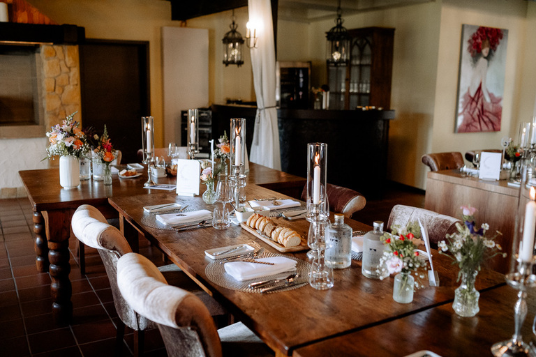 Gedeckte Tafeln in der Moormühle, dekoriert mit Kerzen, Blumen und hochwertigem Geschirr