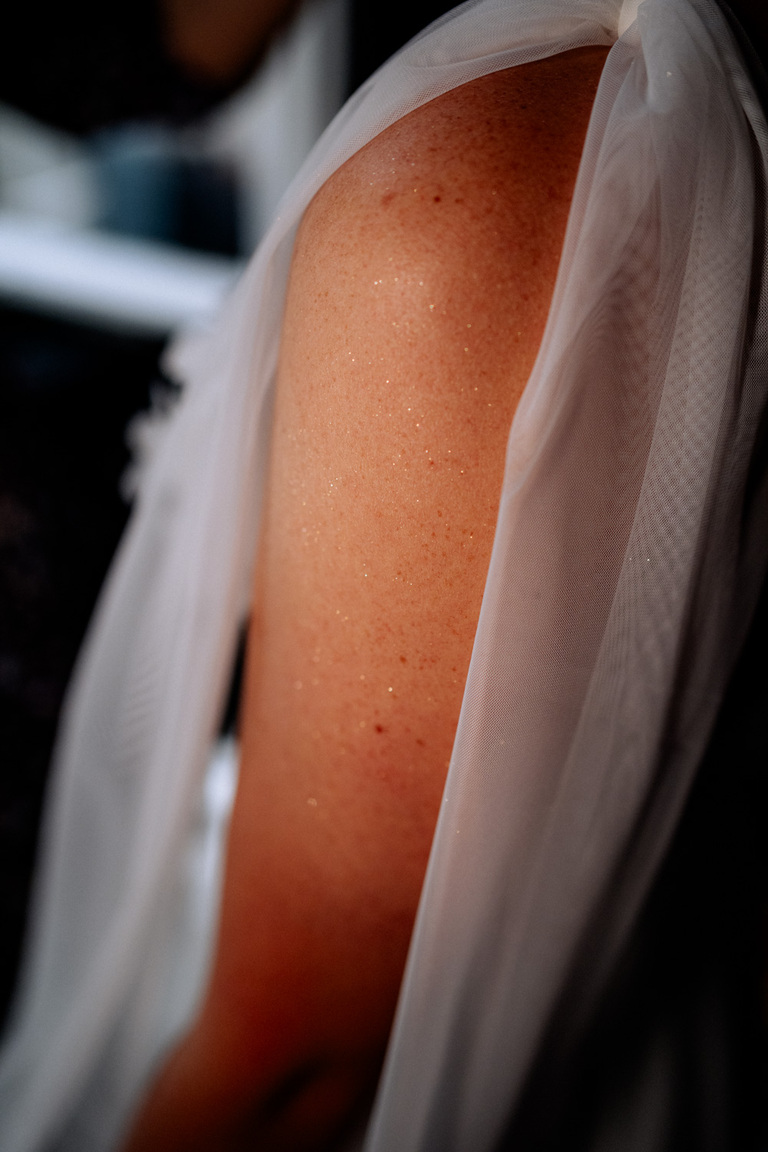 Glitzernde Details am Arm der Braut, aufgenommen auf Schloss Eldingen.