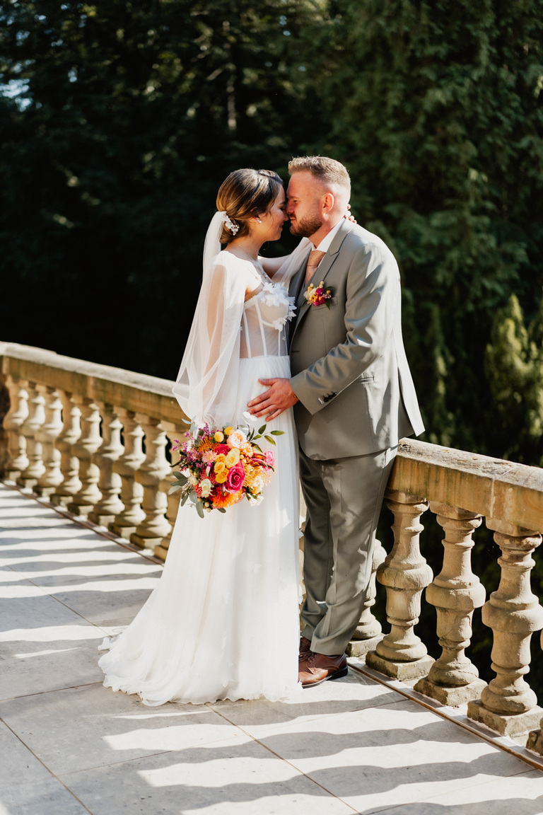 Brautpaar auf dem Balkon von Schloss Eldingen, umgeben von einer romantischen Atmosphäre.