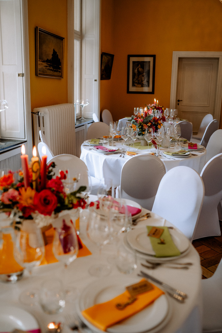 Eine Hochzeitstafel mit kreativer Farbgestaltung und stilvoller Blumendeko im Schloss Eldingen.
